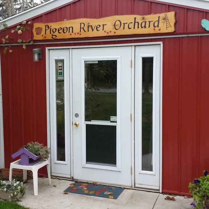 The orchard's red storefront with its hand-painted Pigeon River Orchard sign